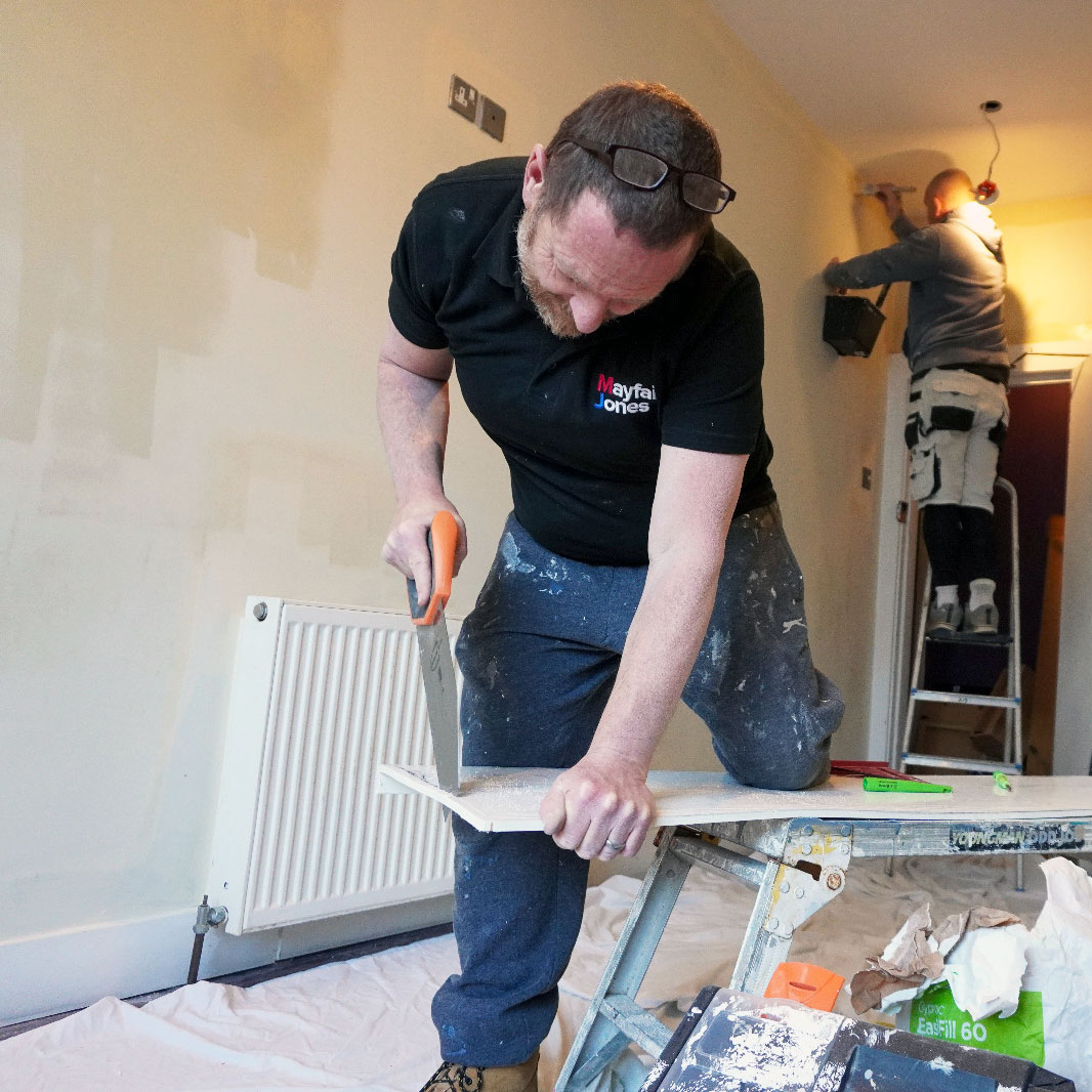 Property maintenance worker using tools